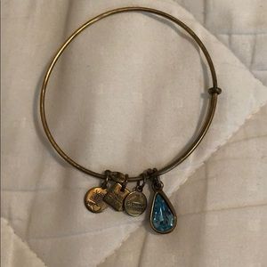 Alex & Ani gold charm bracelet with blue gem